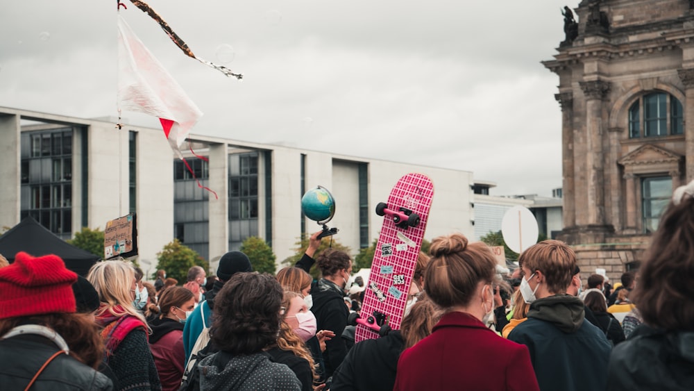 a crowd of people standing in front of a building