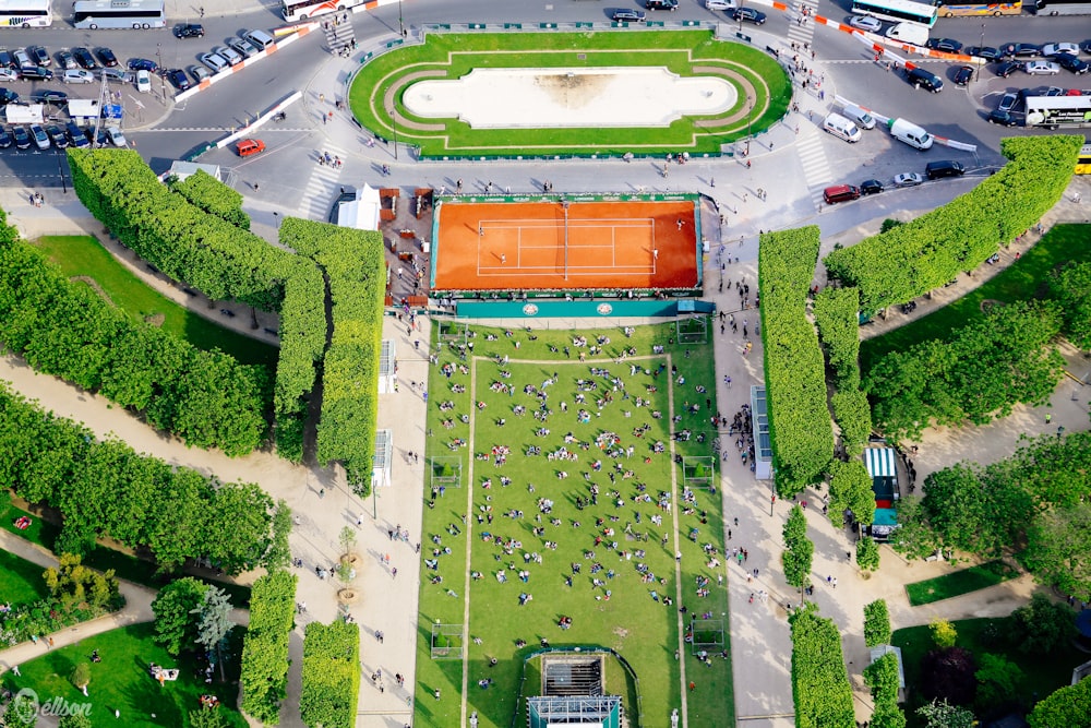 an aerial view of a tennis court surrounded by trees