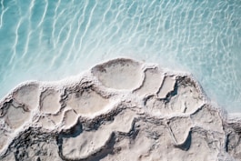 an aerial view of a rock formation in the water