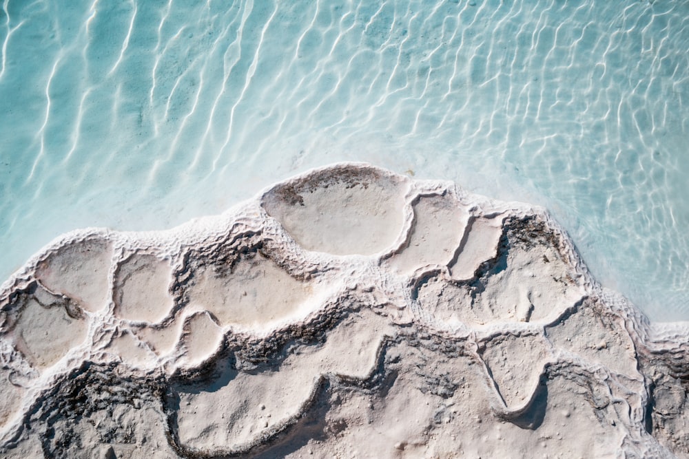 an aerial view of a rock formation in the water