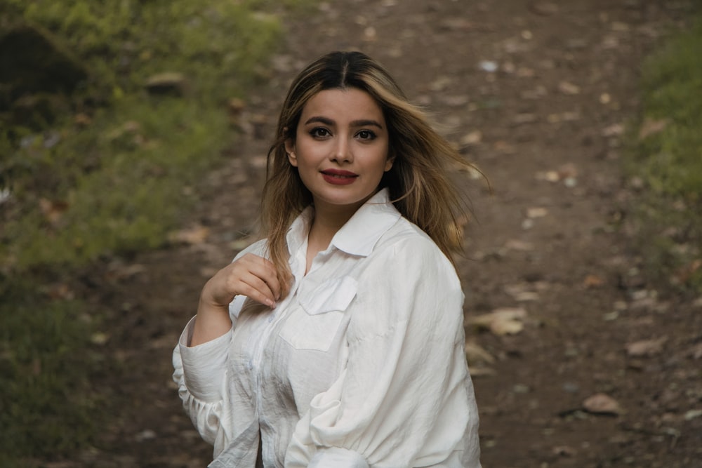 a woman in a white shirt posing for a picture