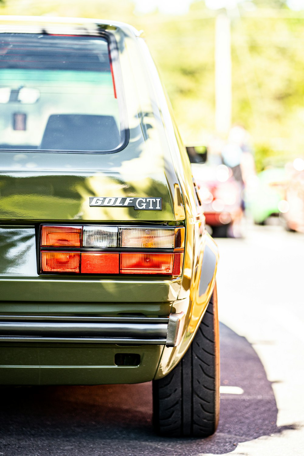 a green car parked on the side of the road