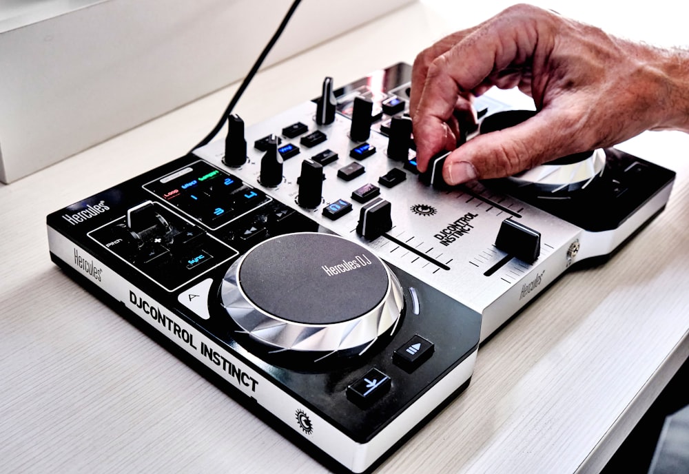 a man is using a dj controller on a table