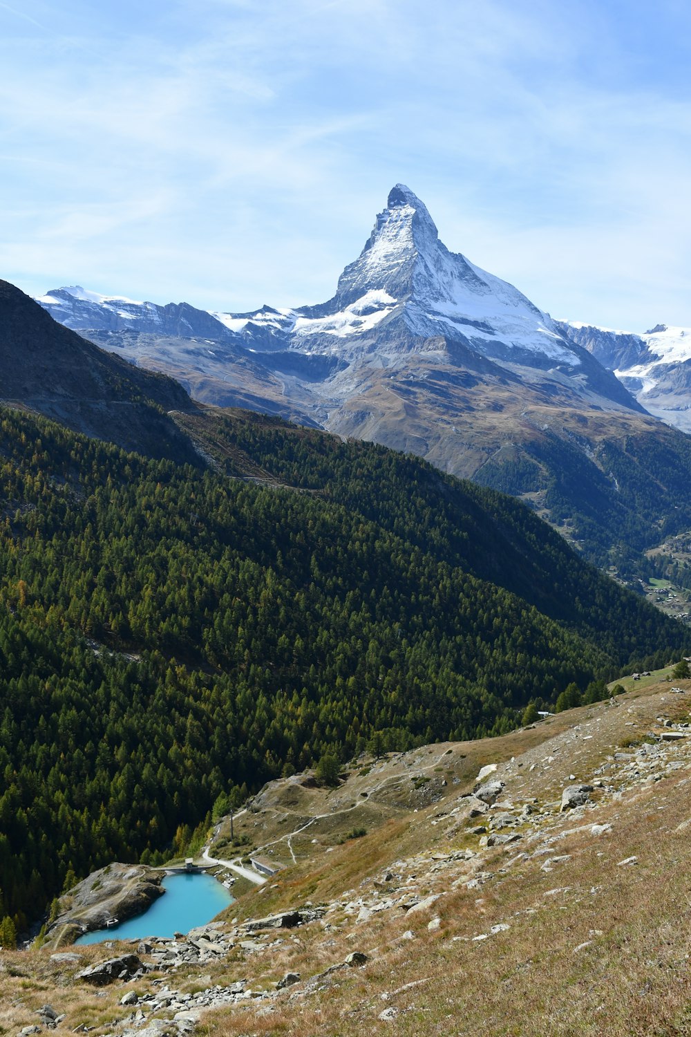 a view of a mountain range with a lake in the foreground