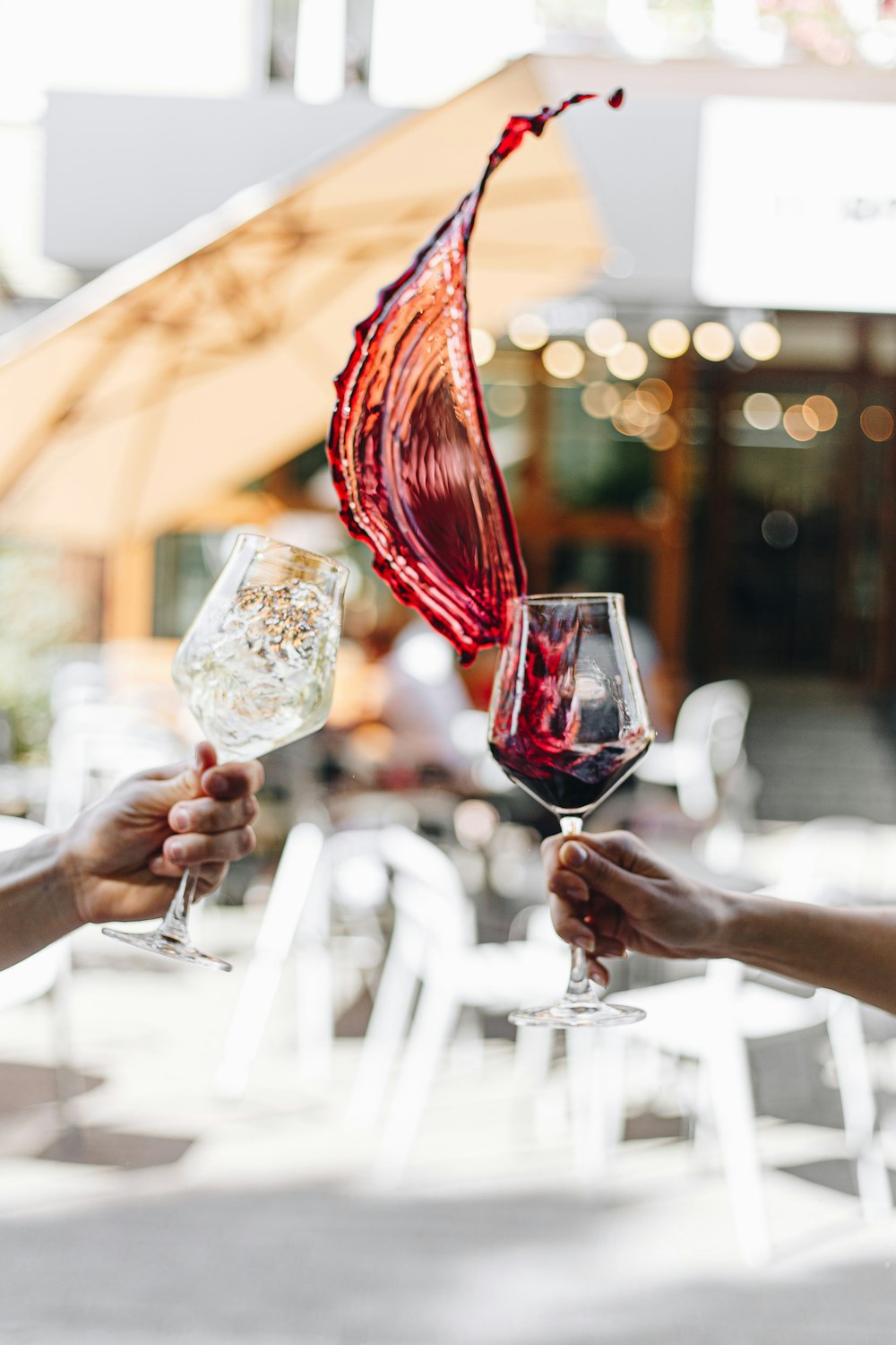 a person holding a wine glass on a table