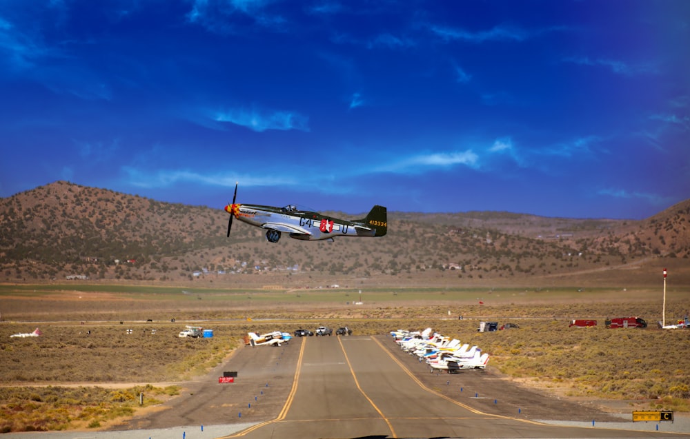 a small plane is flying low over a runway