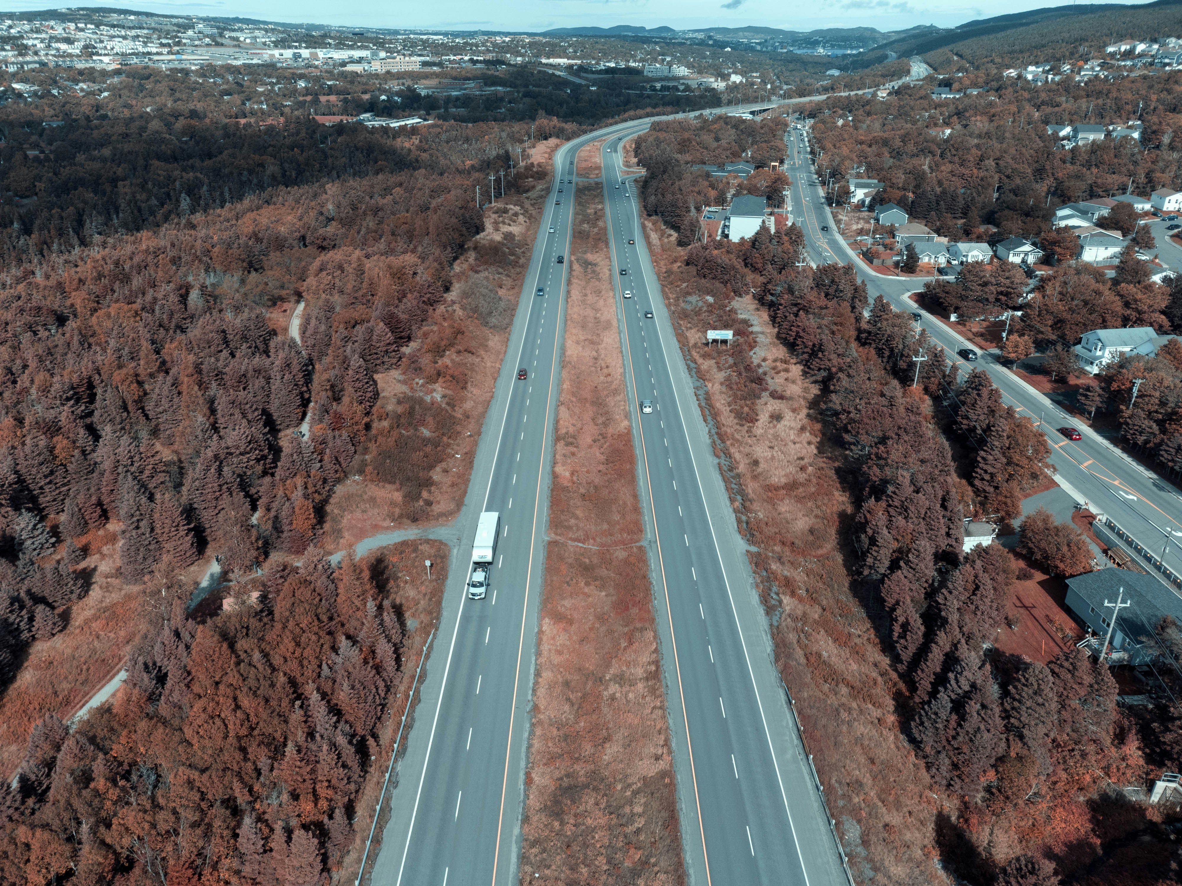 an aerial view of a highway surrounded by trees