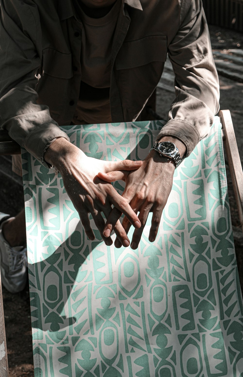 a man sitting at a table with his hands on the table