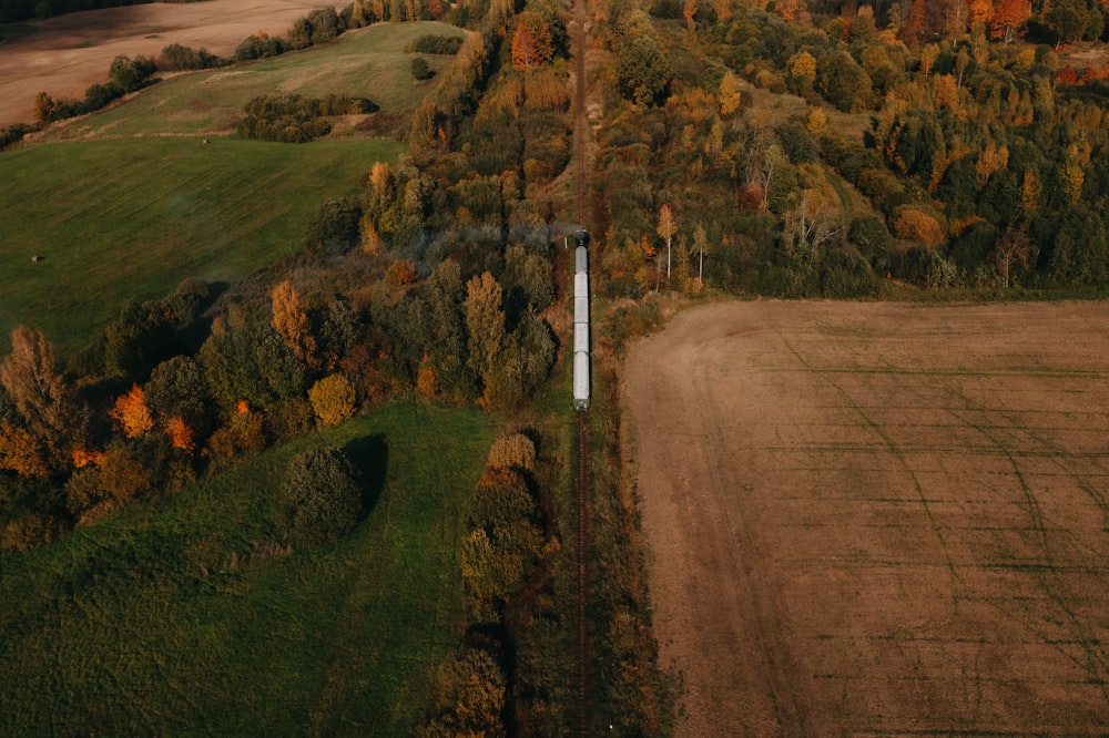 an aerial view of a field with a train on it