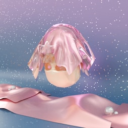 a pink object is floating in the air