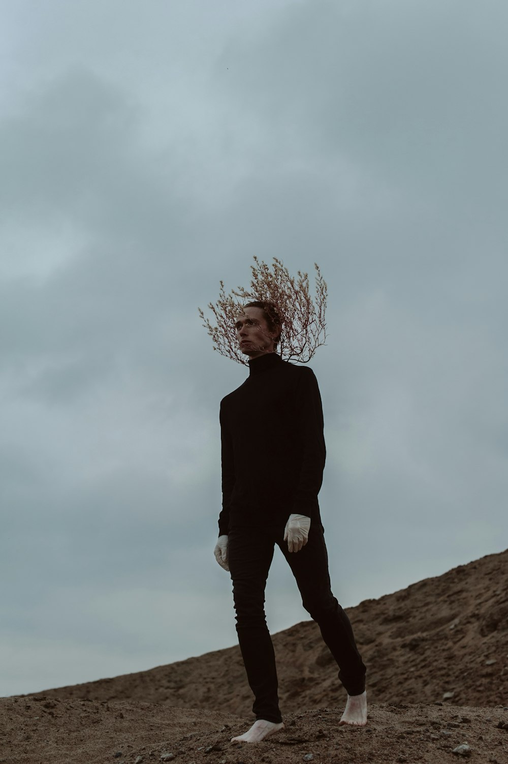 a man standing on top of a dirt hill