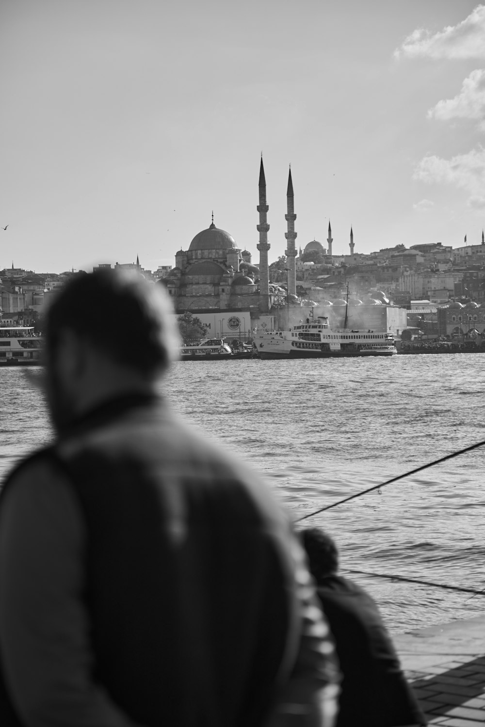 a black and white photo of a man fishing