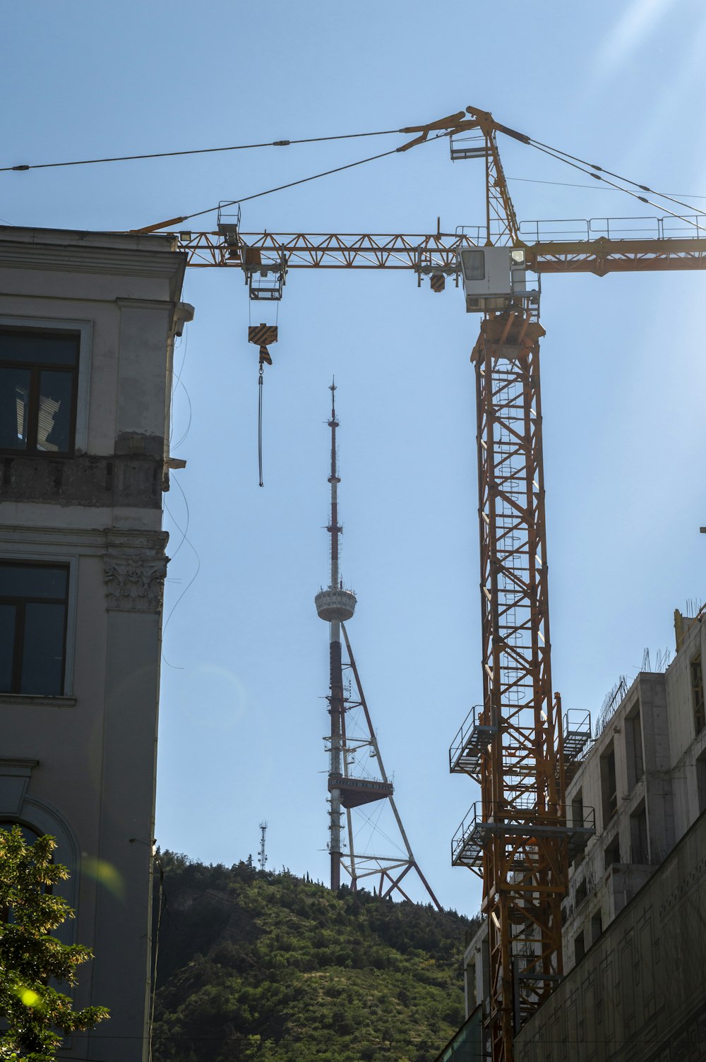 a crane is standing in front of a building