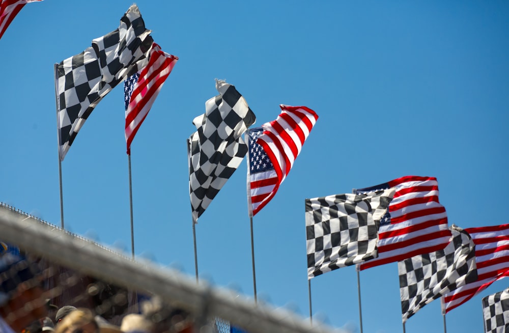 a row of checkered flags blowing in the wind