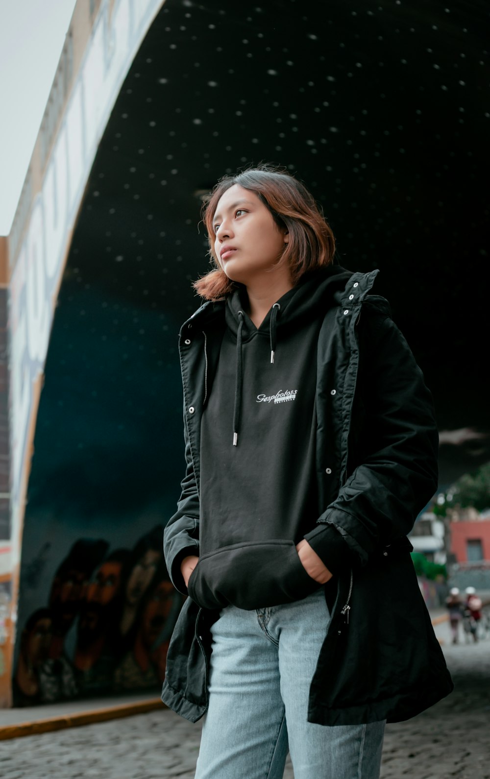 a woman standing in front of a building