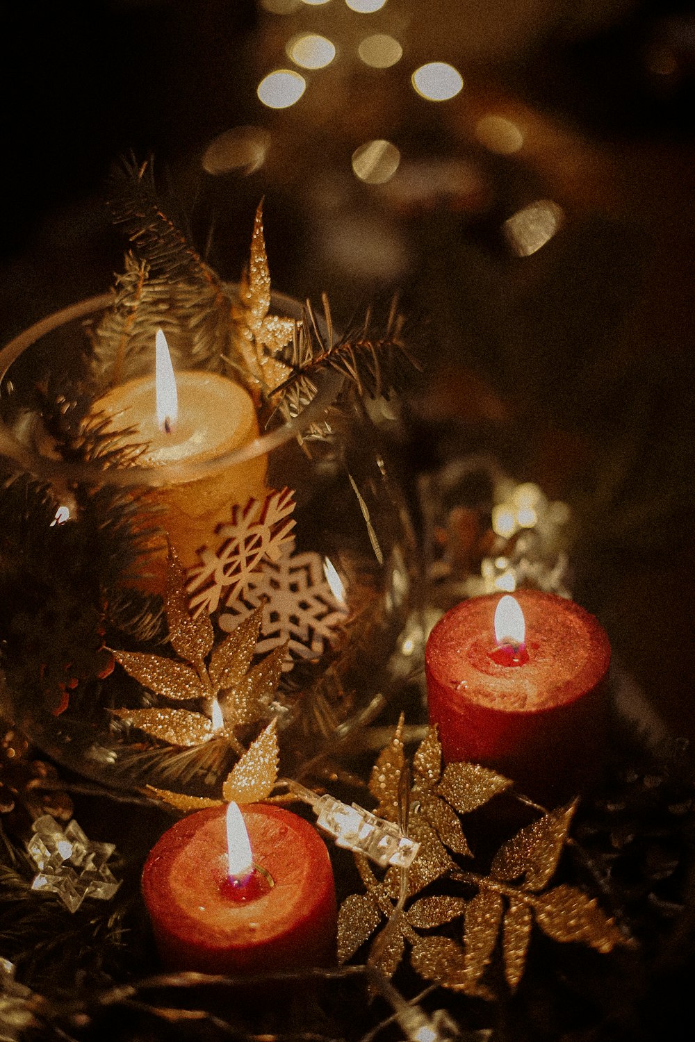 three lit candles sitting on top of a table