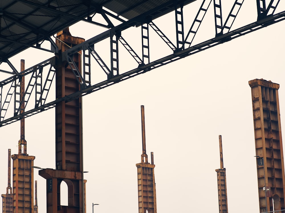 a group of tall metal structures under a gray sky