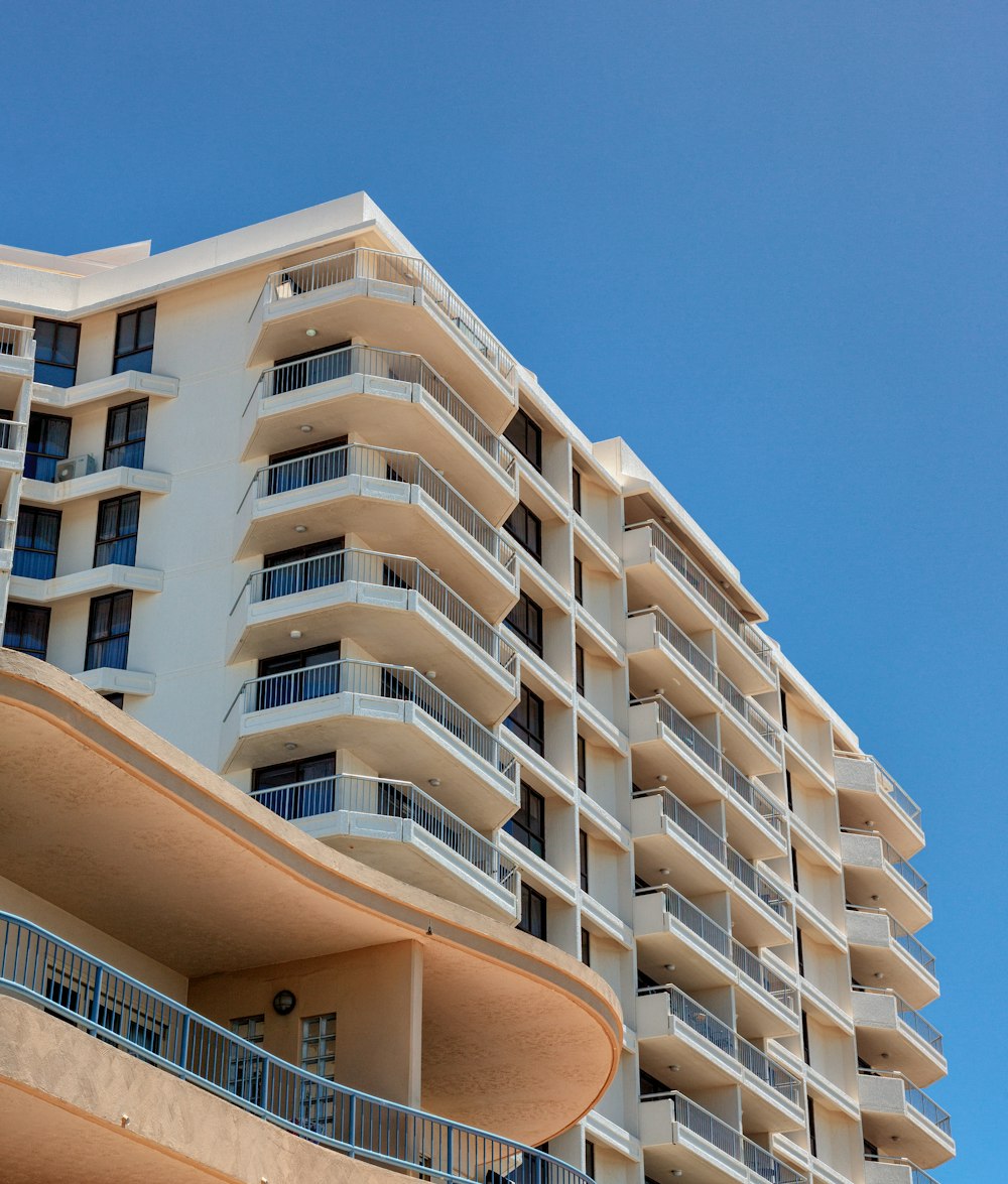 a tall white building with balconies and balconies