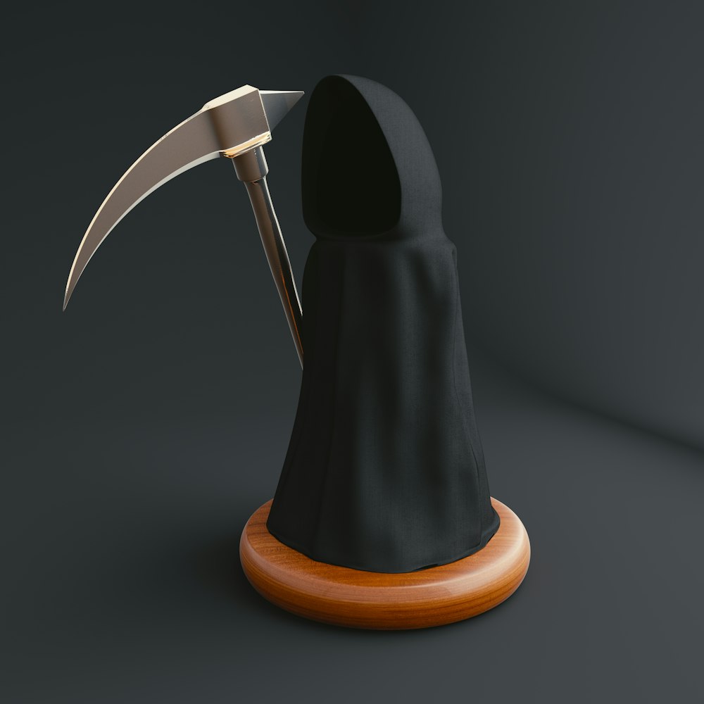 a black and orange object with a large knife sticking out of it