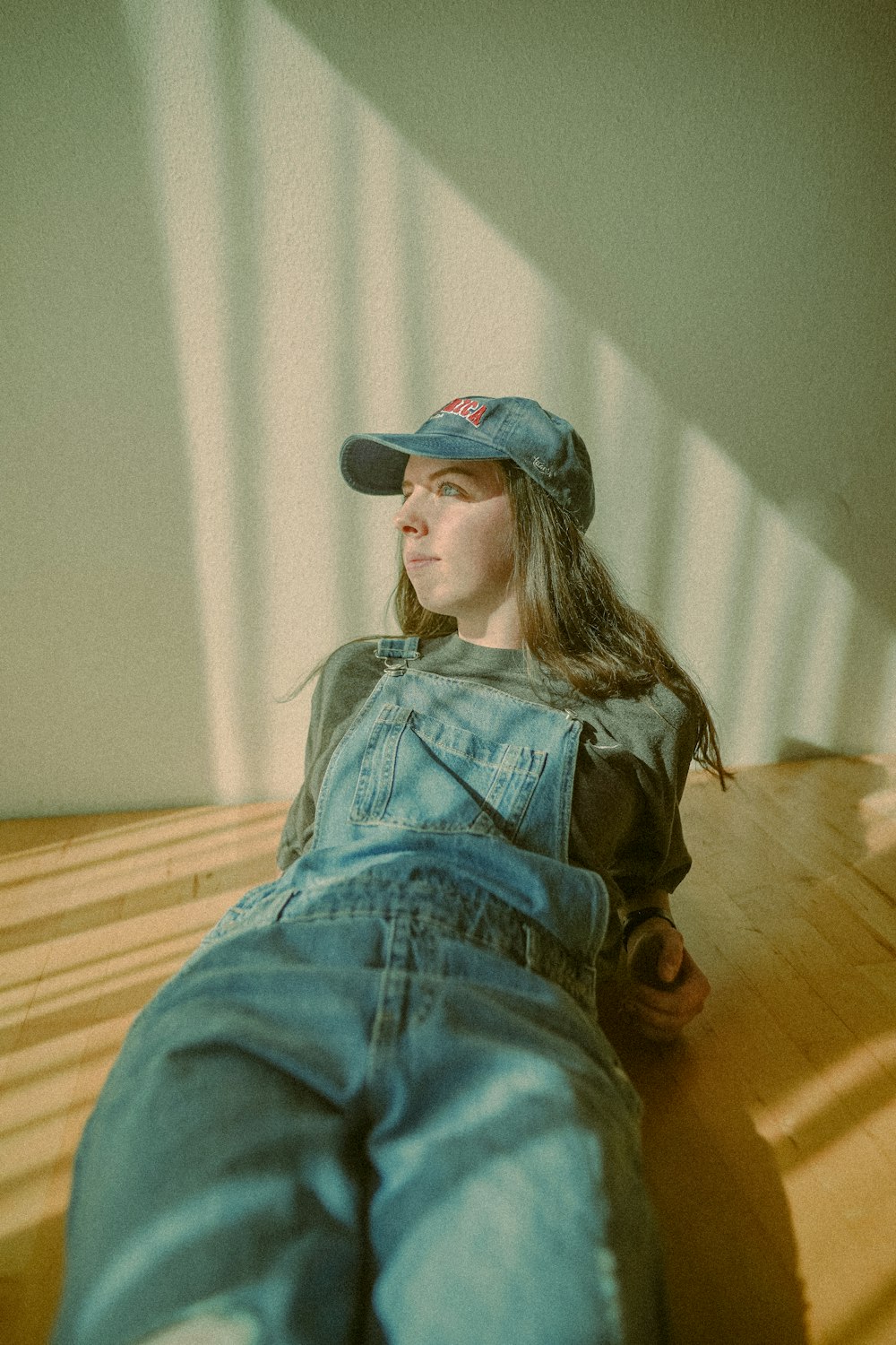 a woman laying on the floor wearing a hat