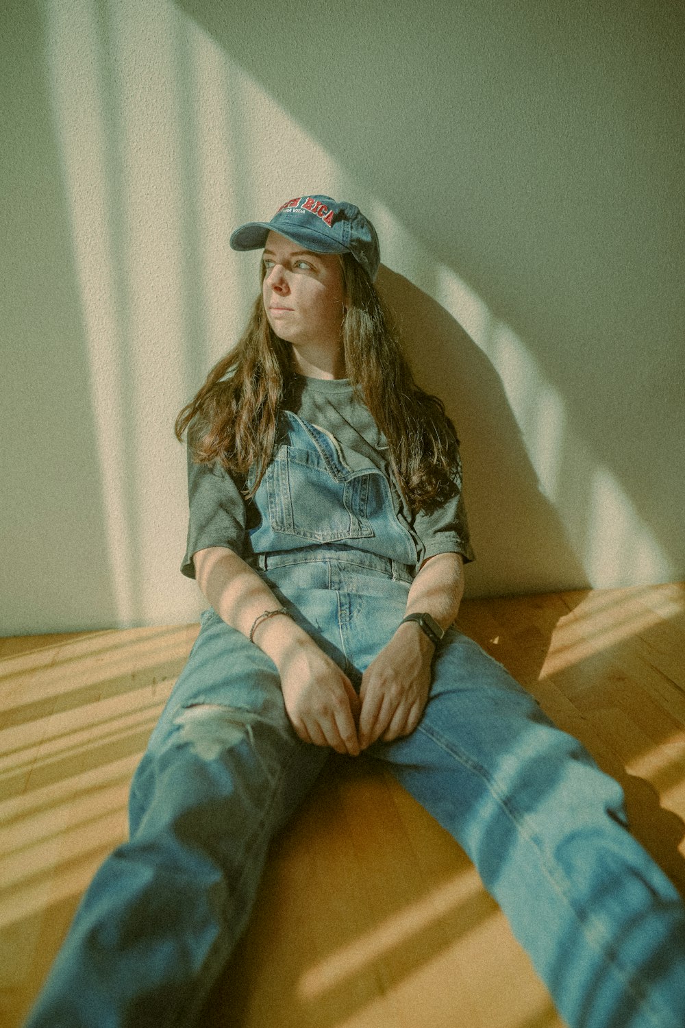 a woman sitting on the floor with her legs crossed