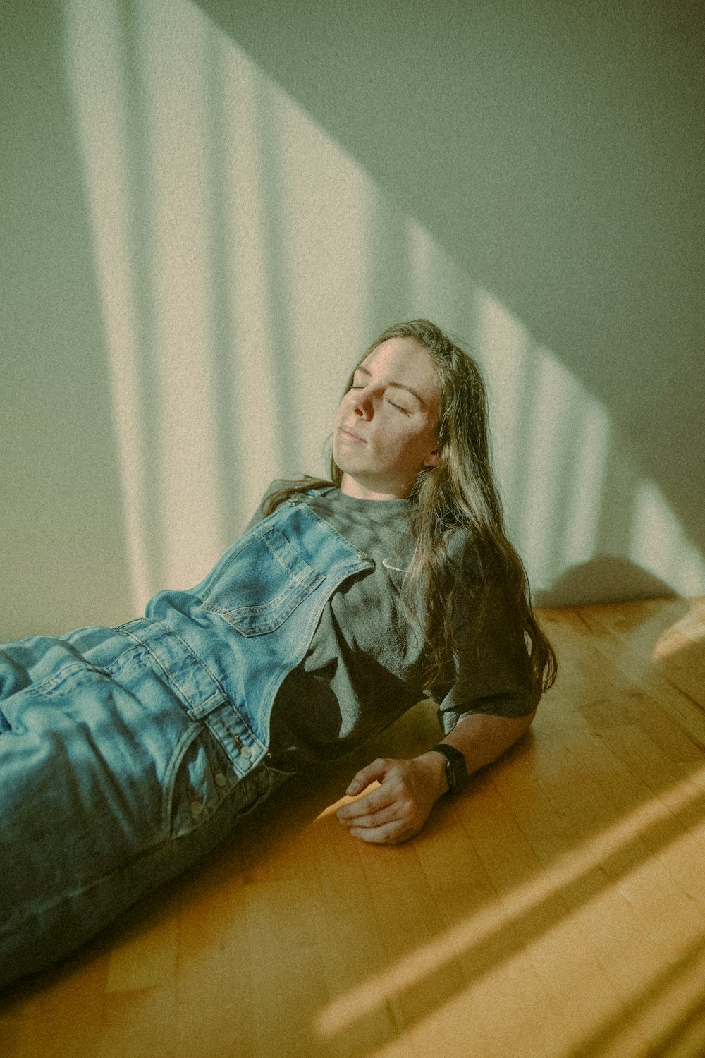 a woman laying on the floor with her eyes closed