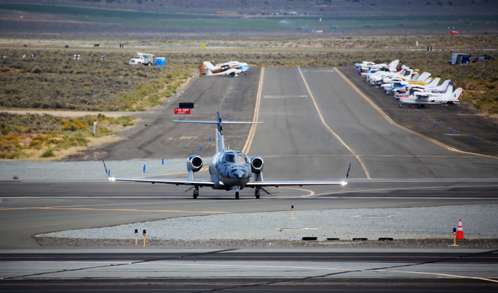 a small airplane is on the runway of an airport