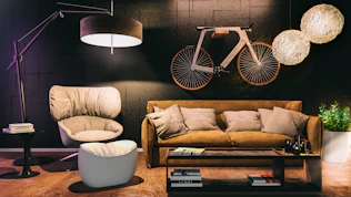 a living room filled with furniture and a bike mounted to the wall