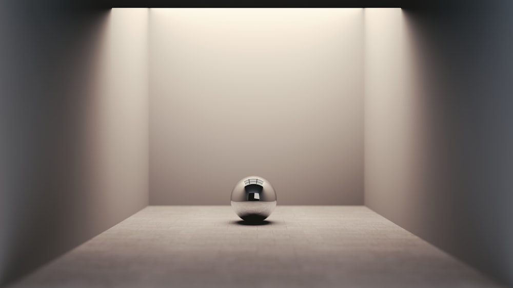 an empty room with a white ball on the floor