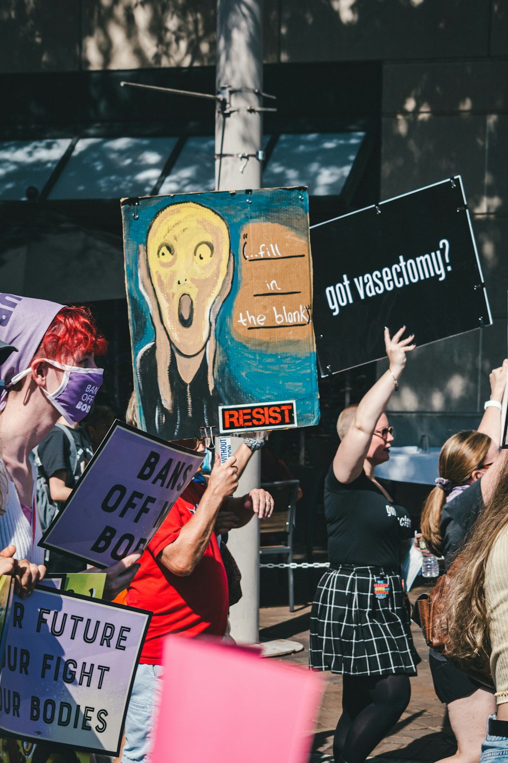 a group of people holding signs in the air