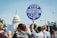 A group of people gather near a prominent building, holding various protest signs advocating for keeping abortion legal. The atmosphere suggests a demonstration or rally with individuals of diverse backgrounds actively participating.