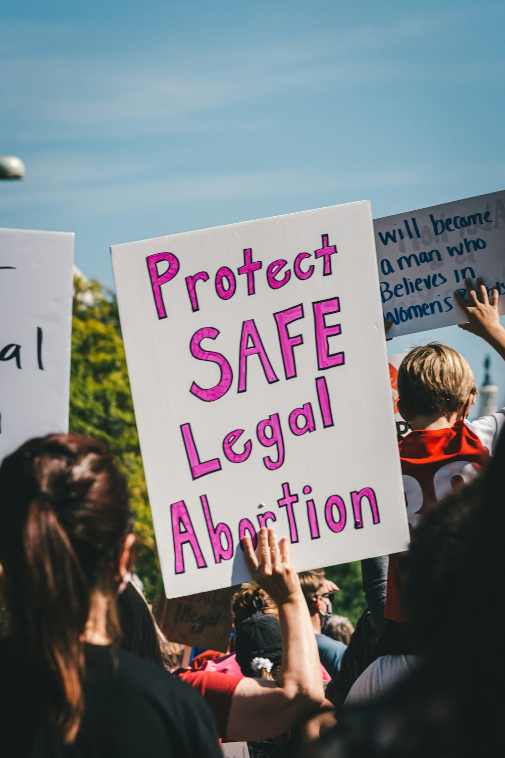 a group of people holding signs in the air