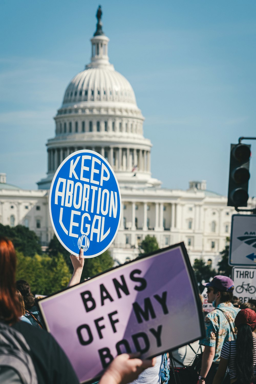 a person holding a sign that says bans of my body