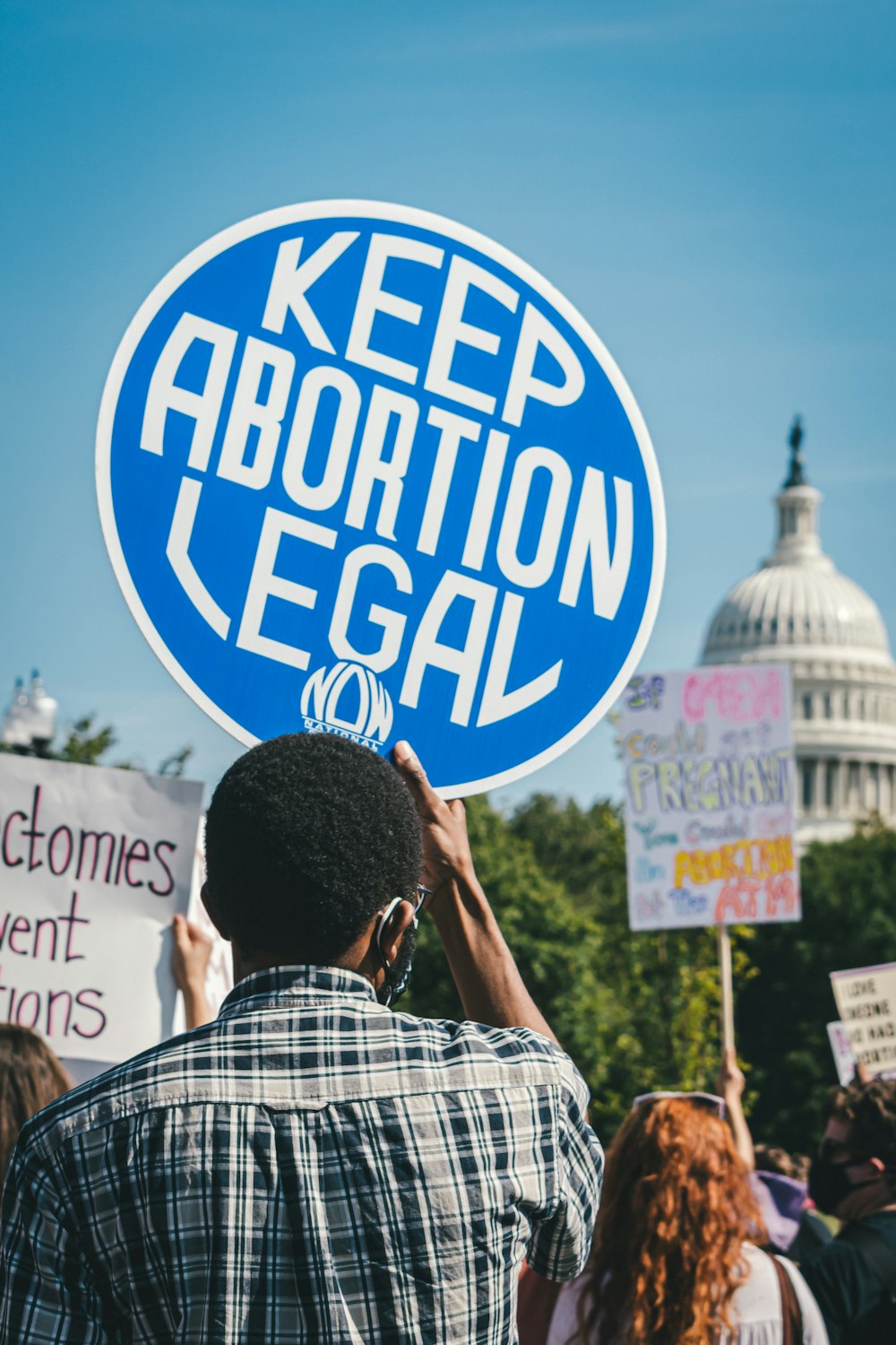 Un hombre sosteniendo un cartel que dice mantener el aborto legal