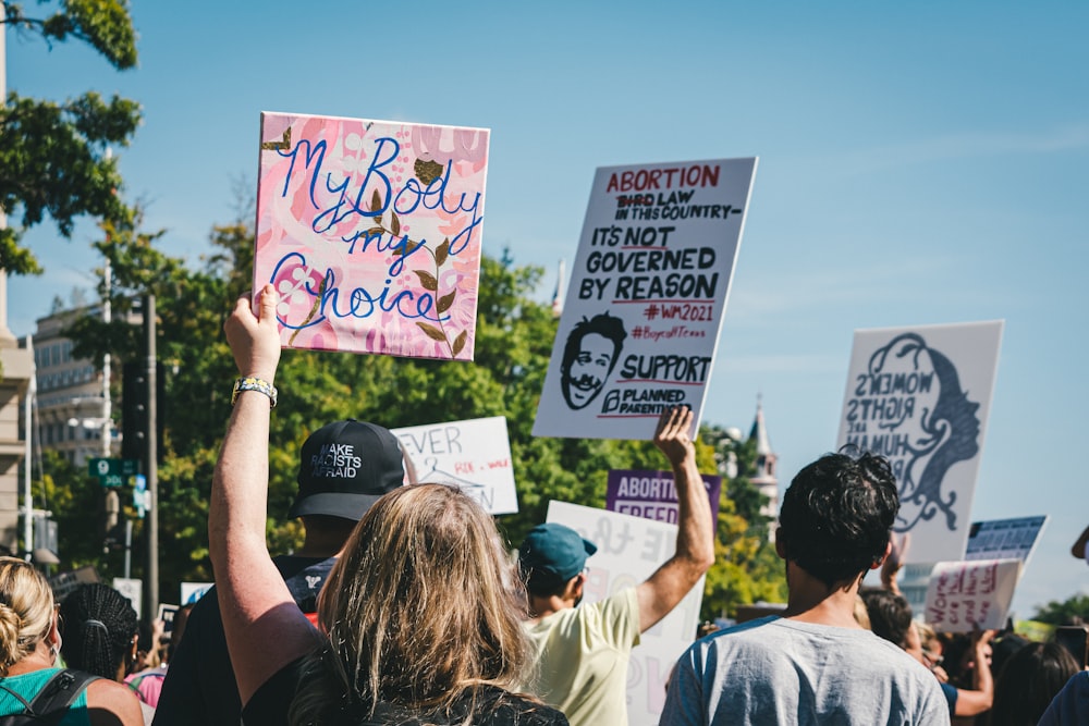 a group of people holding up signs in the air