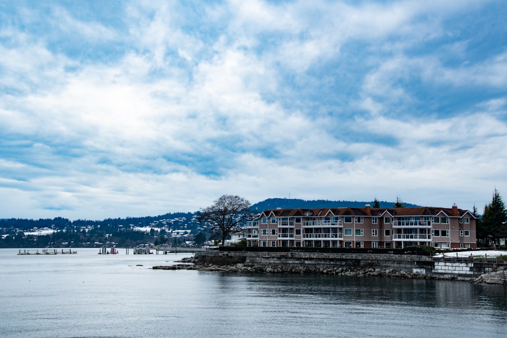 a large building sitting on the shore of a lake