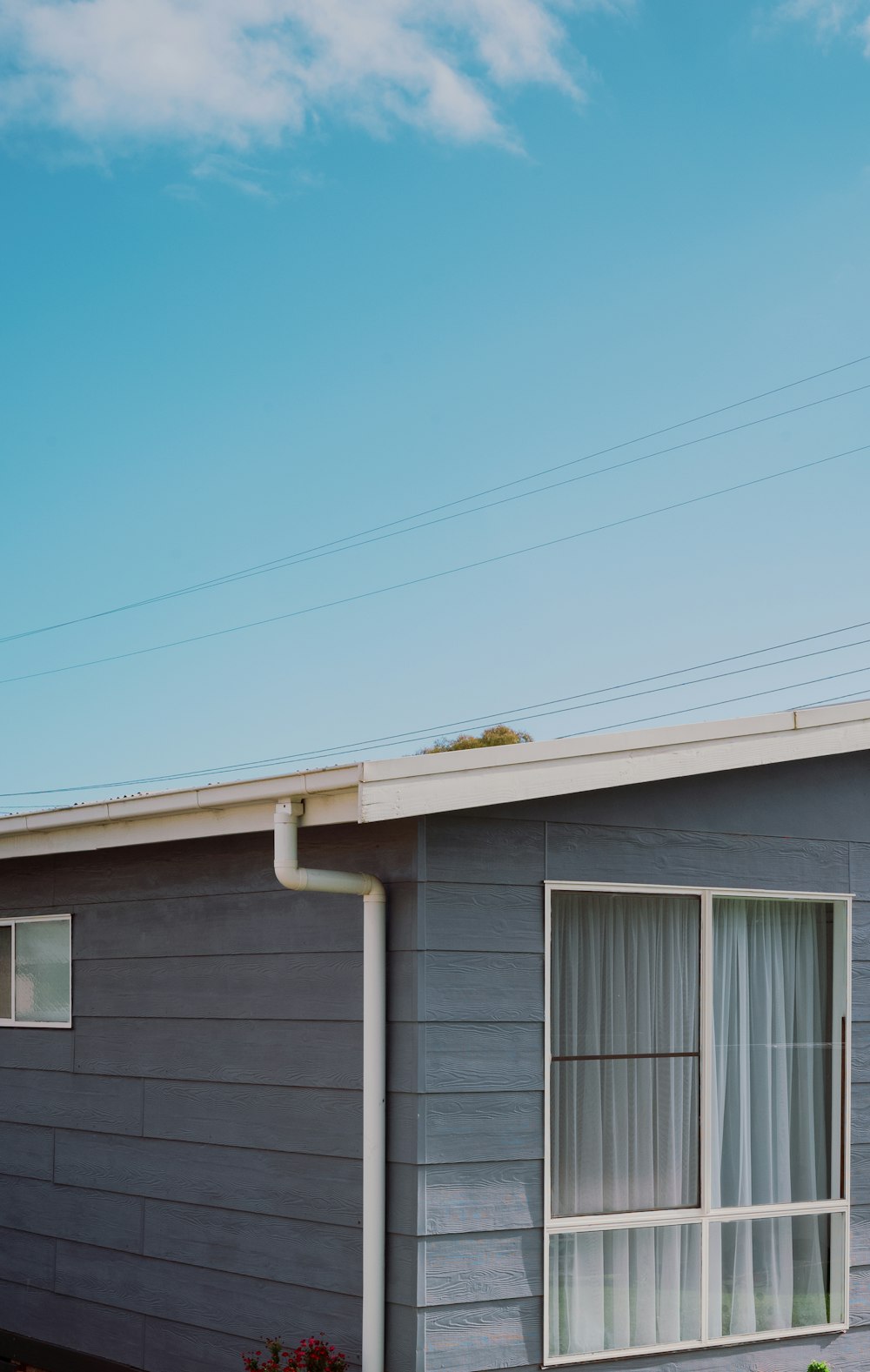 a house with a blue sky and clouds in the background