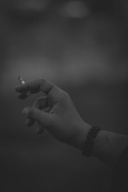 a person holding a cigarette in their hand