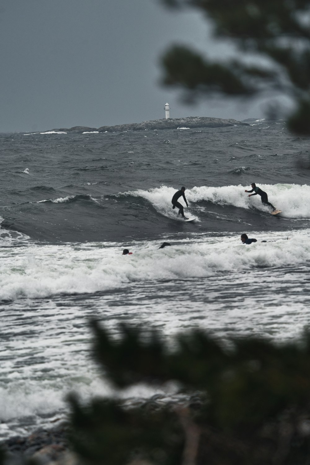 a couple of surfers riding a wave in the ocean