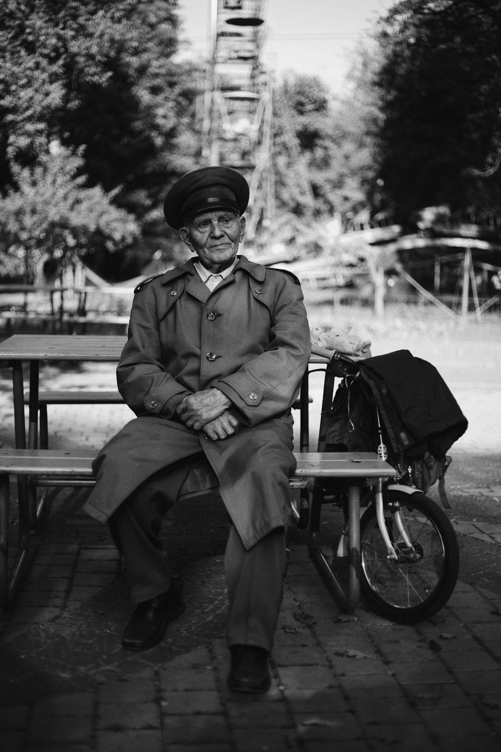 a man sitting on a bench next to a bike