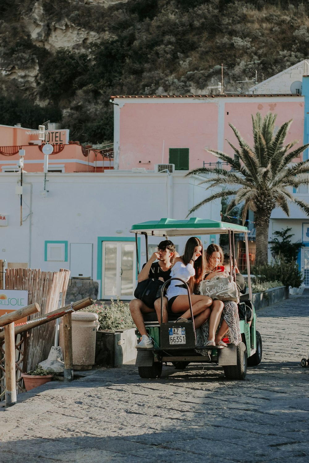 a group of people riding on the back of a golf cart