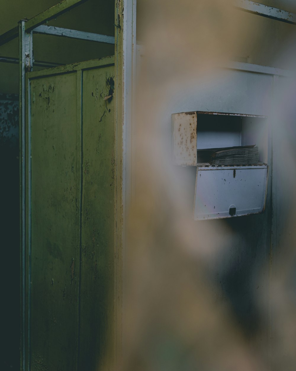 a green door with a drawer in it