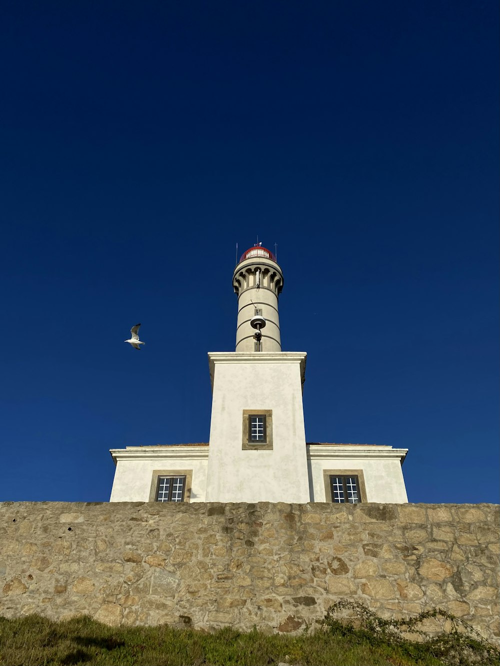 a lighthouse on top of a stone wall