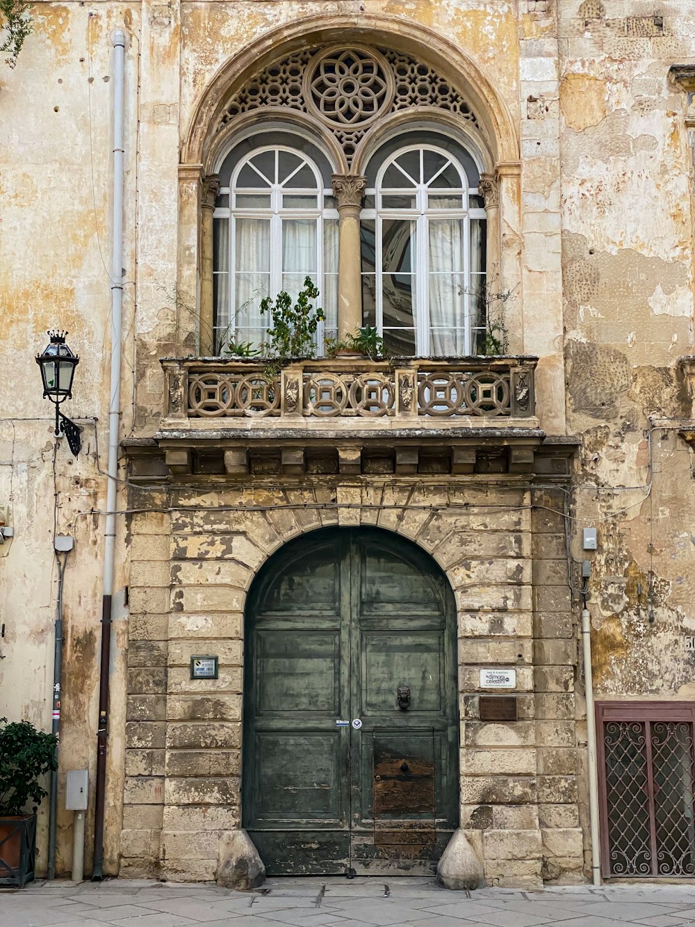 an old building with a green door and window