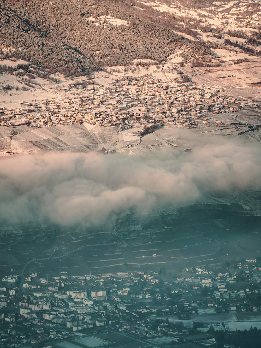 an aerial view of a city with a mountain in the background