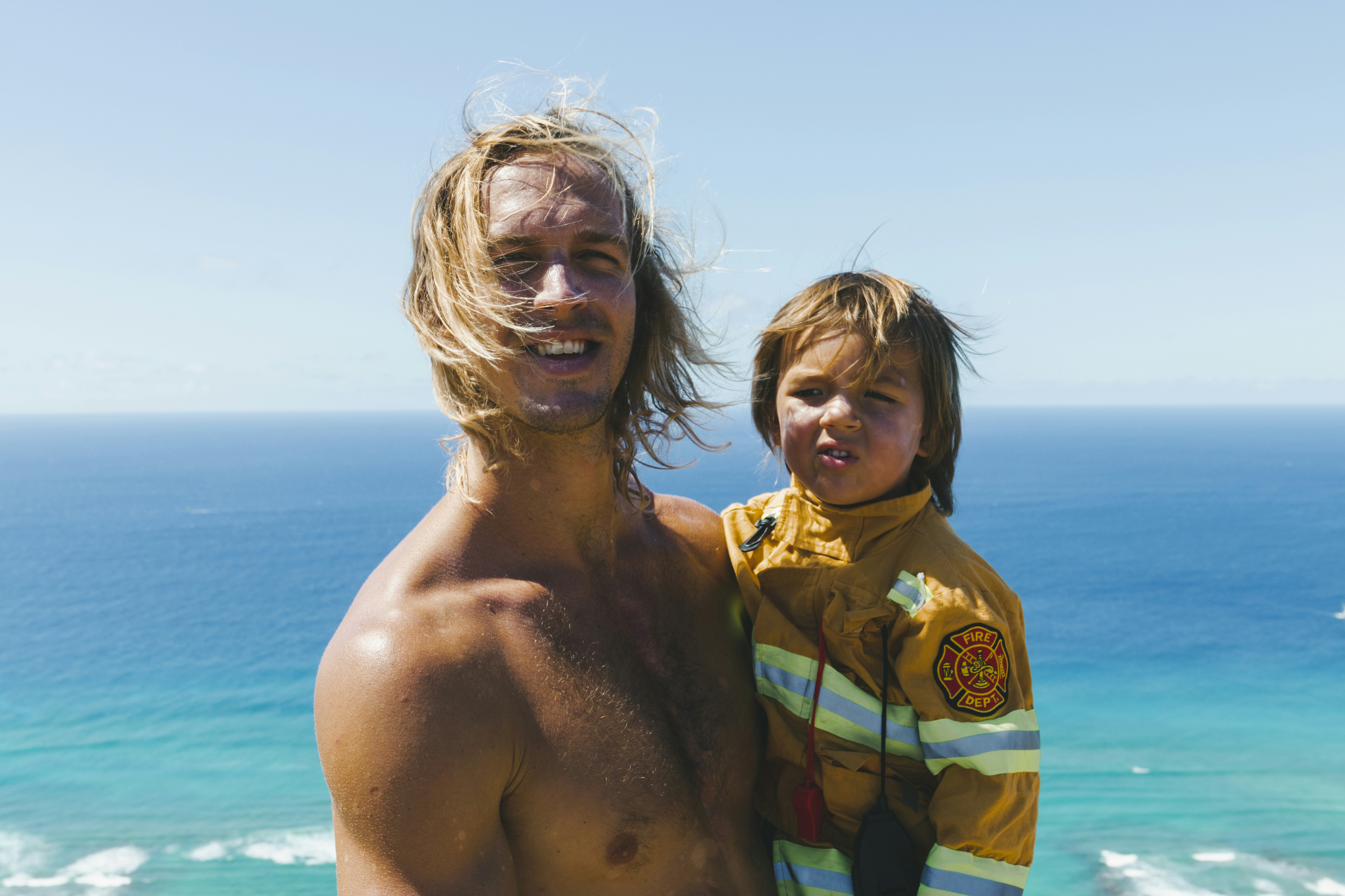 a man and a child standing on a beach