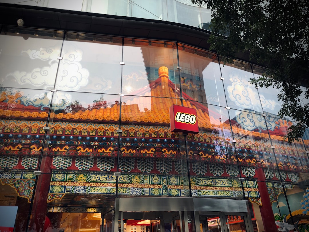 a store front with a reflection of a building in the glass,
