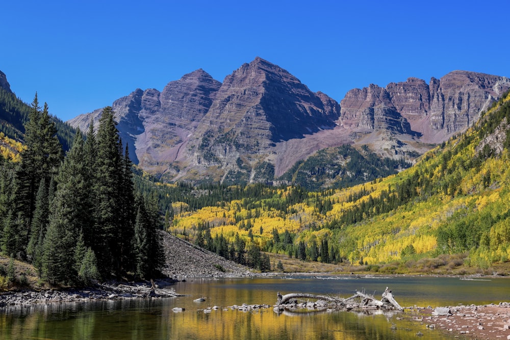 a mountain range with a lake in the foreground