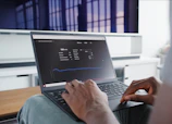 a person sitting in front of a laptop computer