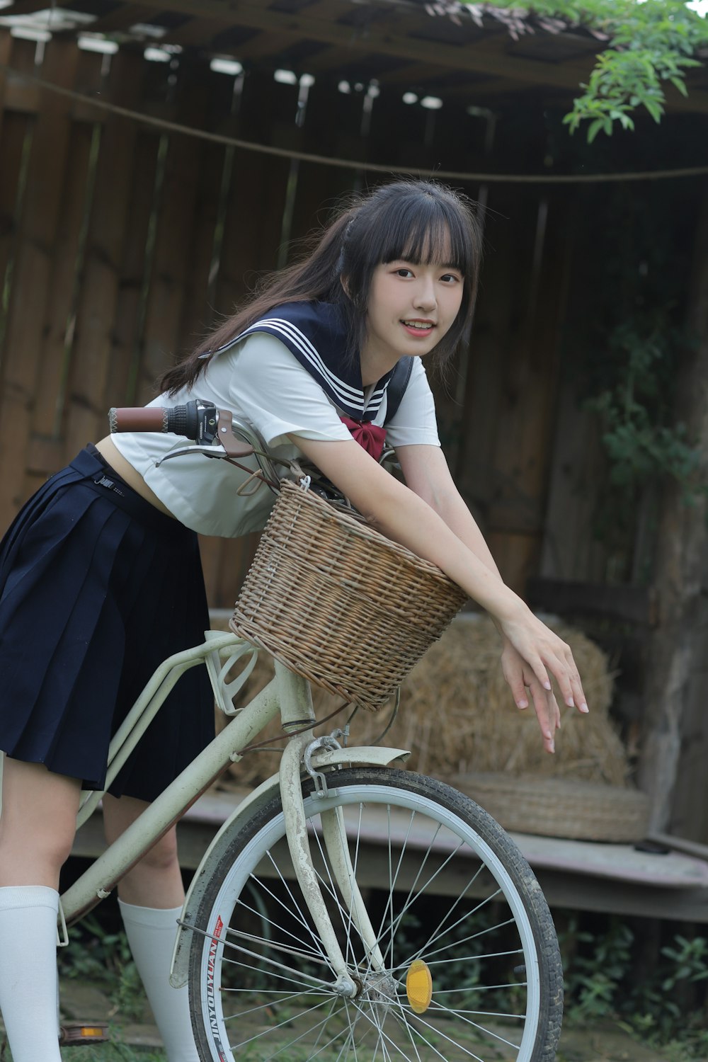 a woman riding a bike with a basket on the back of it